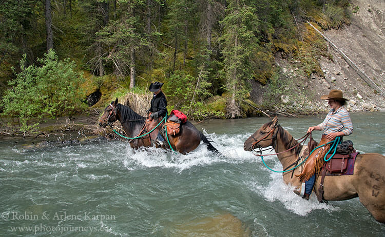 A young woman riding a horse, part of horse, front view in Banff