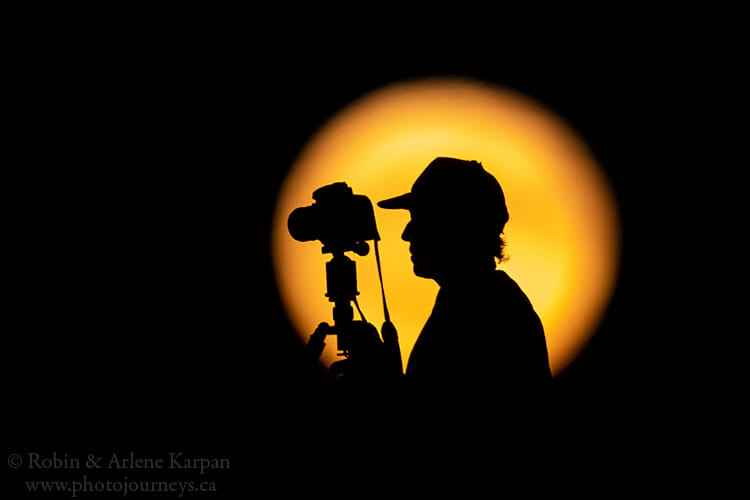 Silhouette in front of full moon.
