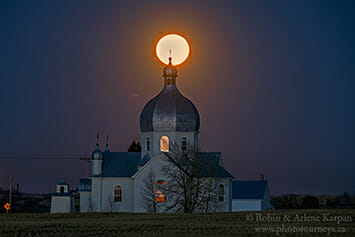 Full moon over church at Smuts, Saskatchewan
