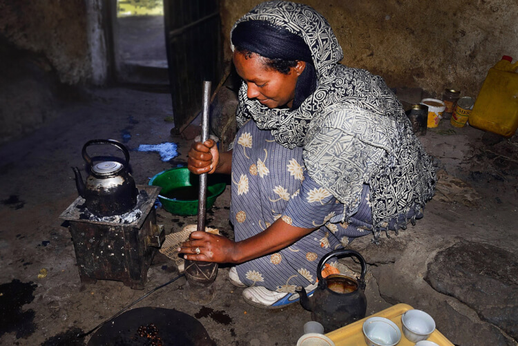 Pounding roasted coffee beans, Ethiopia.