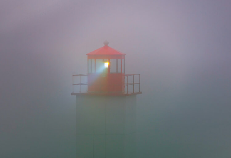 Fog surrounding a lighthouse at St. Martin's, New Brunswick, illustrating bad weather photography.