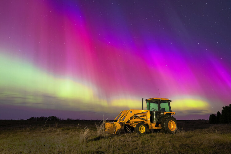 Tractor against northern lights, Saskatchewan.