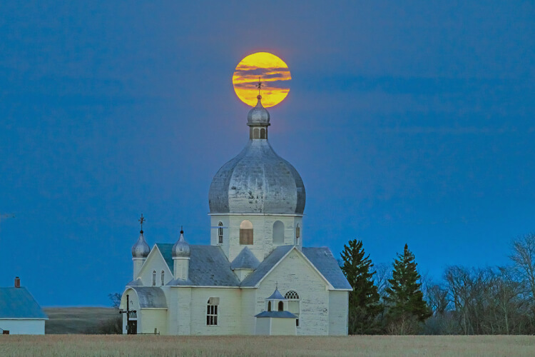 Moonrise over church in Smuts, Saskatchewan