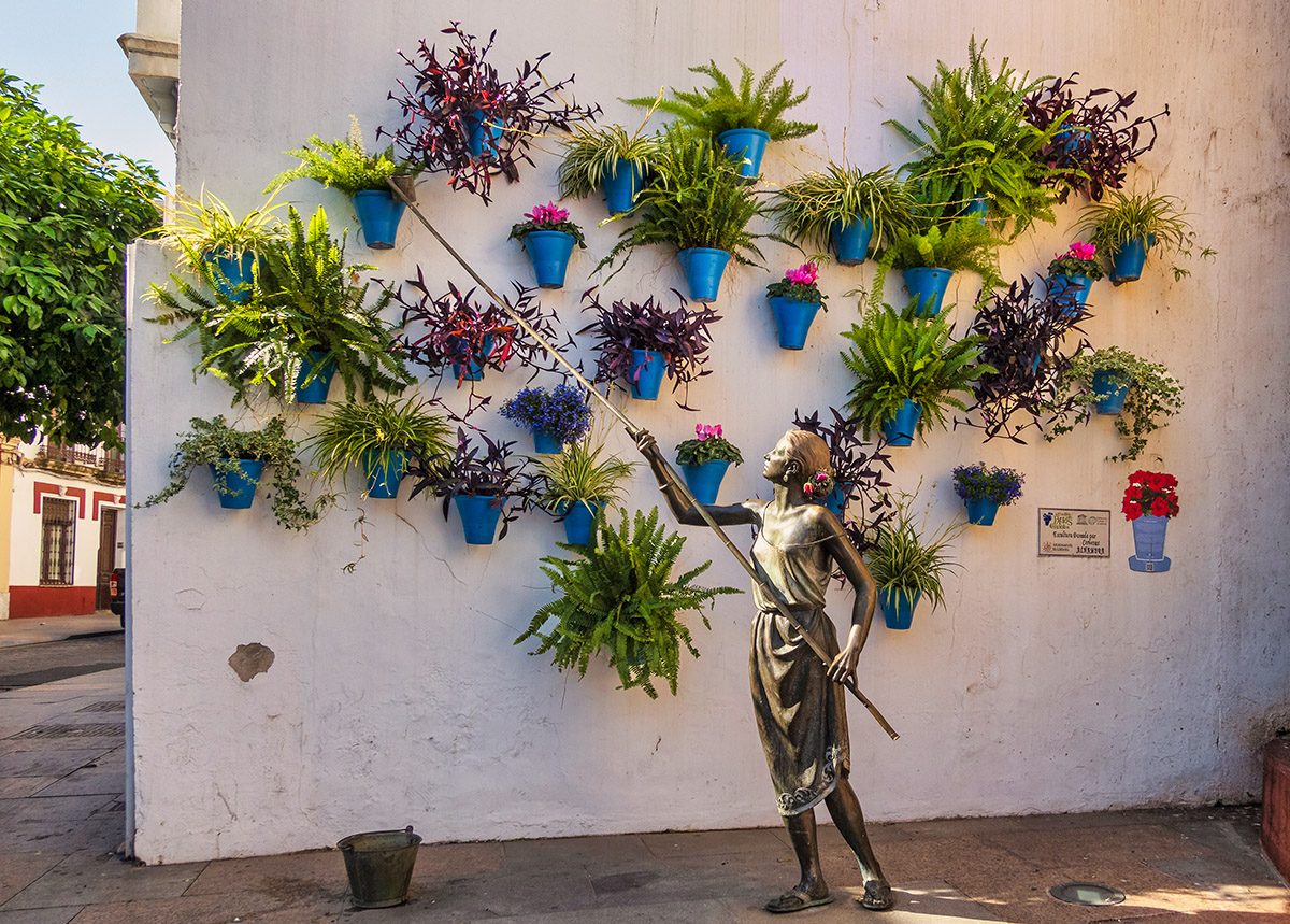 Sculpture of woman watering plants, Cordoba, Spain.