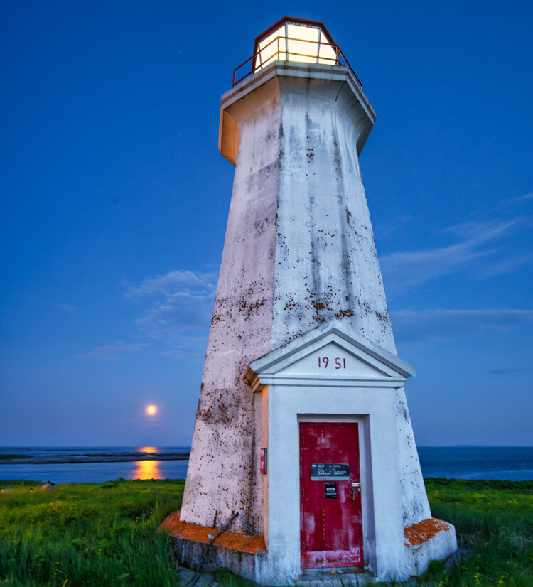Ile aux Perroquets, Quebec, lighthouse and full moon.