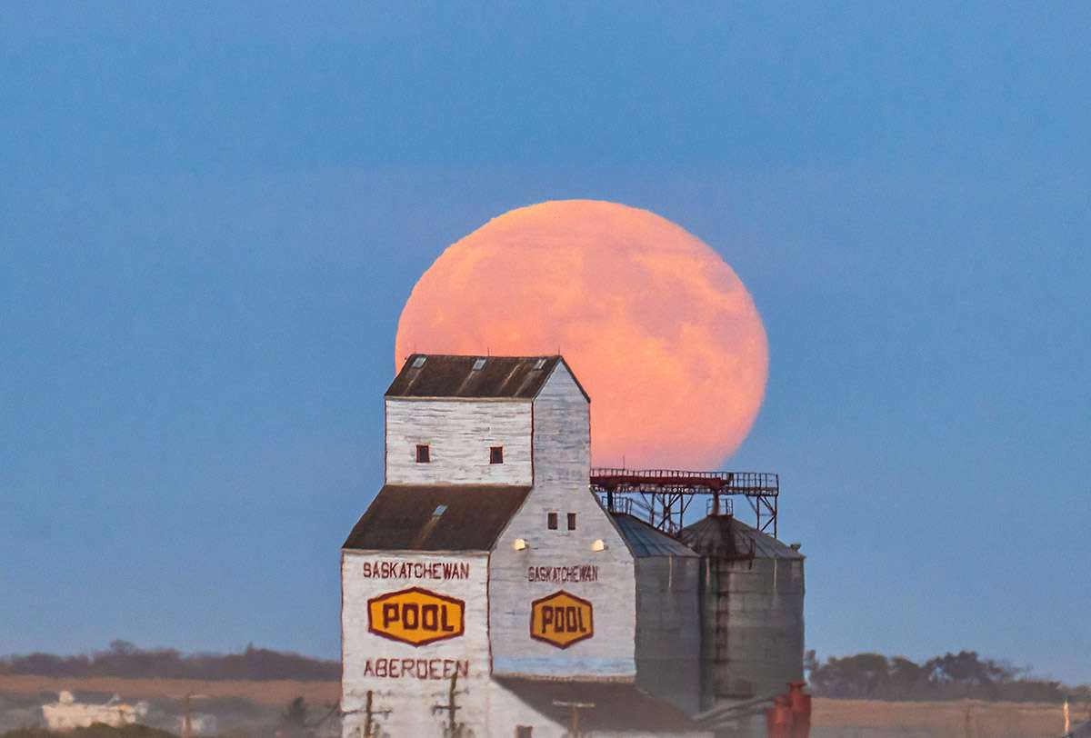 Full moon over grain elevator, Aberdeen, SK