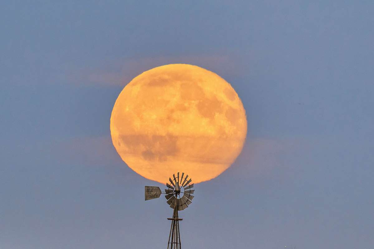 Windmill against full moon.